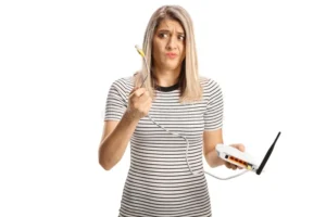 Woman holding old router considering Wi-Fi 7 router upgrade
